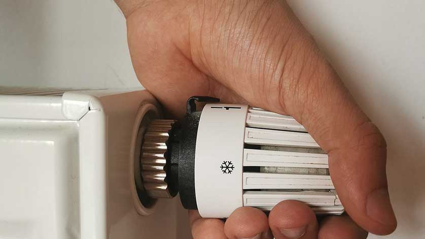 Hand holding a radiator thermostat