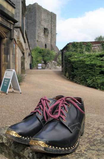 Image of a pair of clogs with Clitheroe Castle in the background.