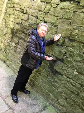 Ricky Newmark, chairman of Ribble Valley Borough Council&rsquo;s community services committee, with a small section of the latest graffiti at the historic Clitheroe Castle Keep.